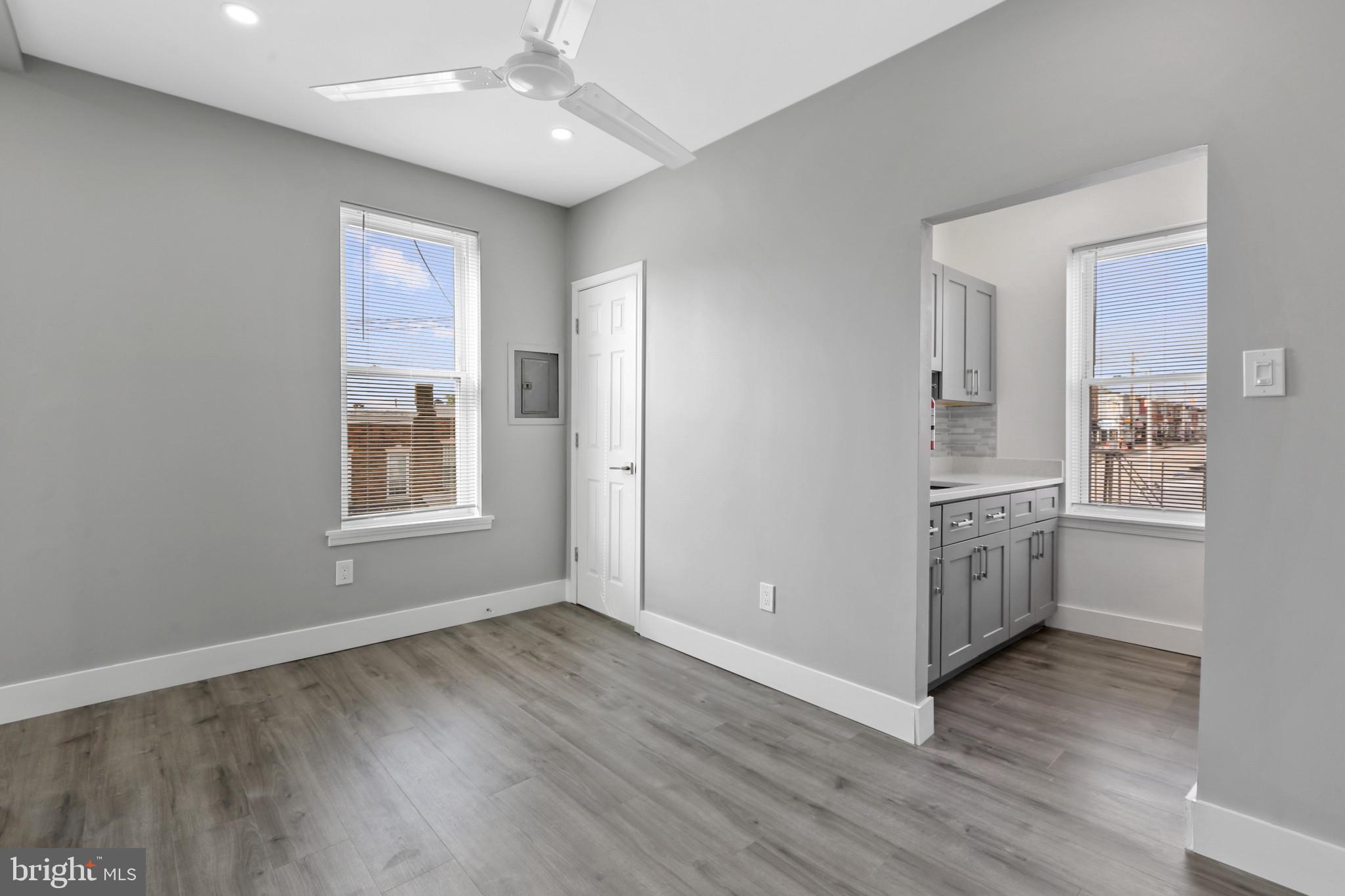 3600 Keswick Road, Unit B Baltimore, MD 21211 - Photo 7 of 23 wooden floor in an empty room with a window