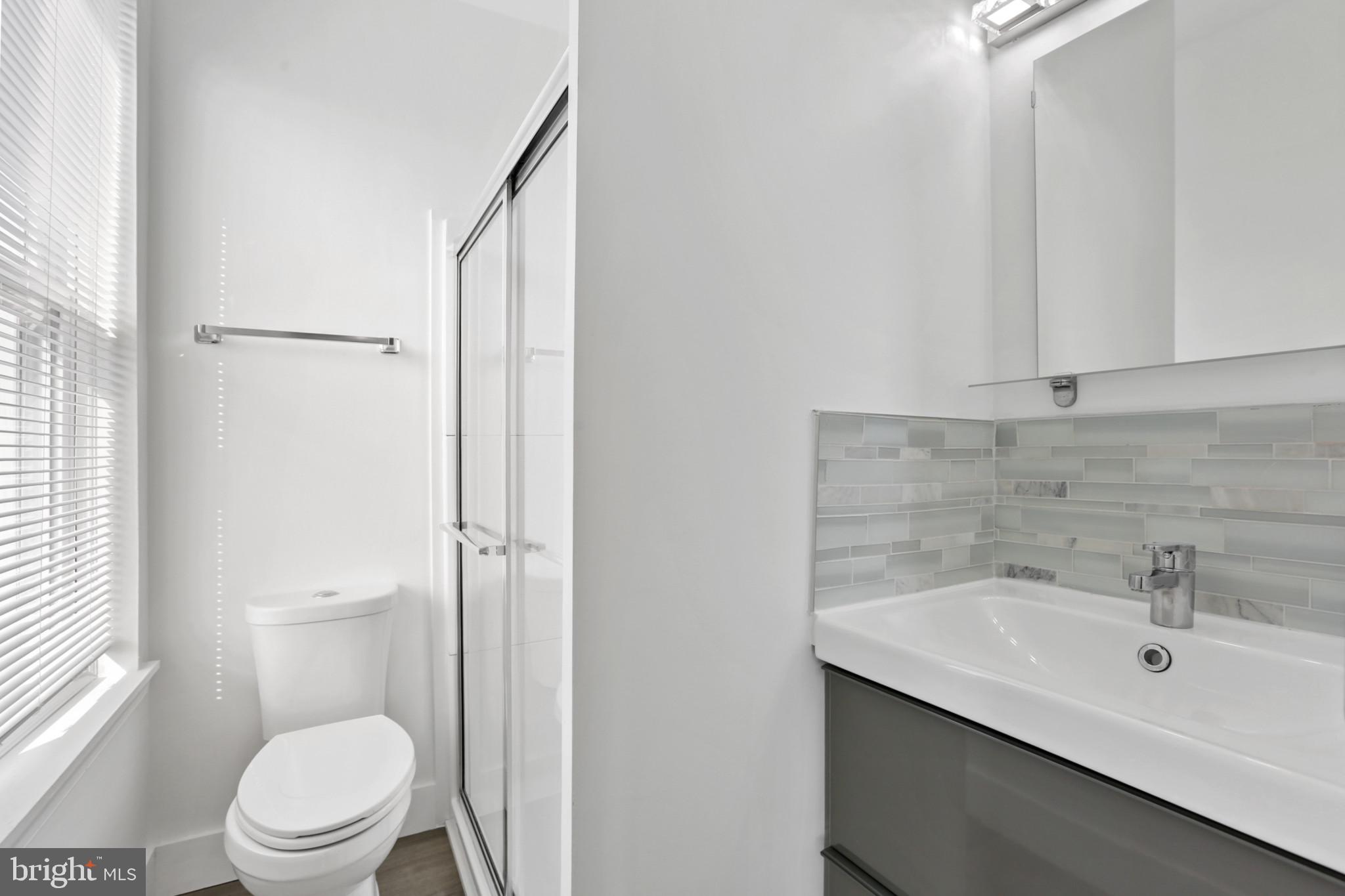 3600 Keswick Road, Unit B Baltimore, MD 21211 - Photo 9 of 23 a bathroom with a sink a toilet and shower