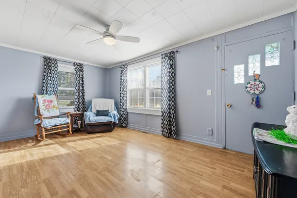 a view of a livingroom with furniture and a window