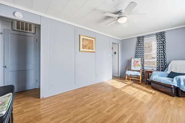 a bedroom with furniture and a ceiling fan