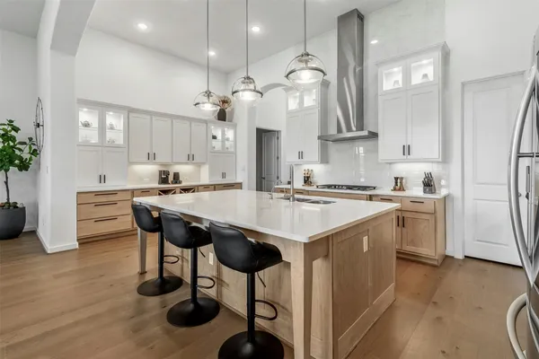 a kitchen with a sink cabinets and wooden floor