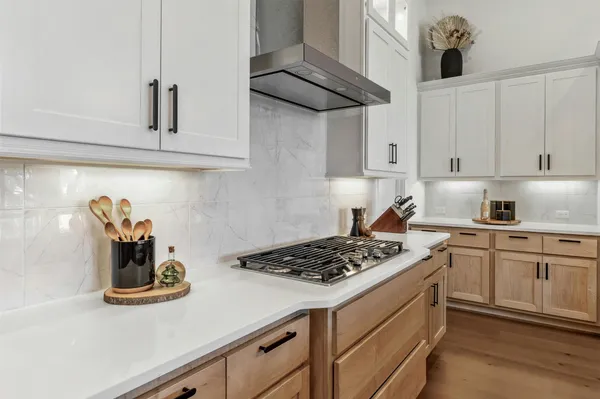 a kitchen with stainless steel appliances granite countertop white cabinets and a stove