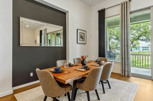 a view of a dining room with furniture window and wooden floor