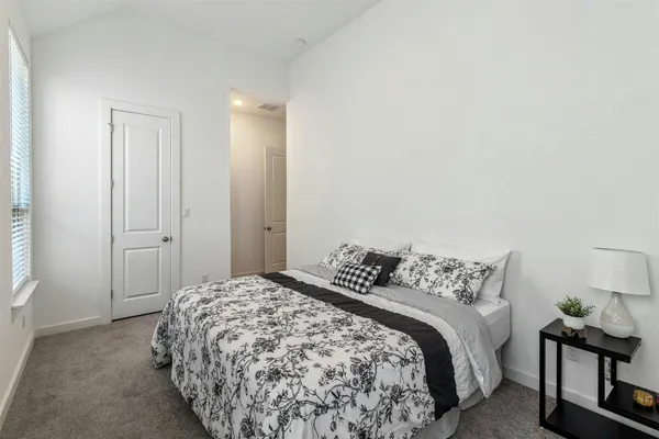 a bedroom with a bed and chair
