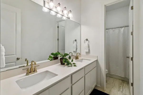 a bathroom with a sink double vanity and a mirror