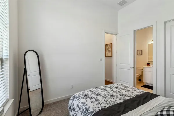 a bedroom with a bed and a mirror