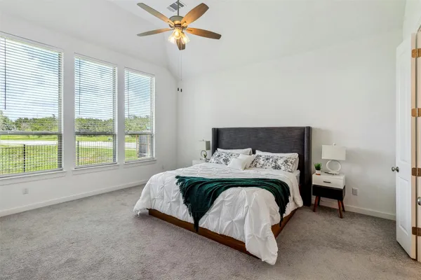 a spacious bedroom with a bed and a window