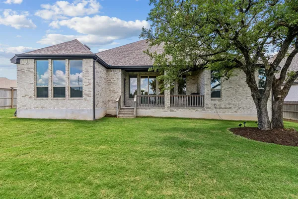 a view of a house with a backyard