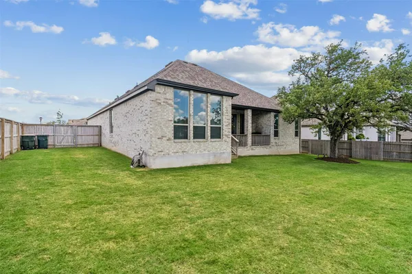 a view of a house with a backyard