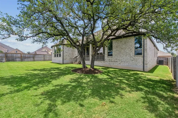 a view of a house with a backyard