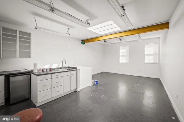 a kitchen with sink and cabinets