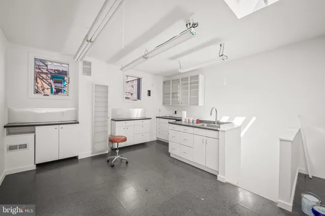 a room with sink cabinets and furniture