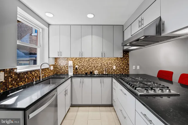 a kitchen with stainless steel appliances a sink dishwasher stove and refrigerator