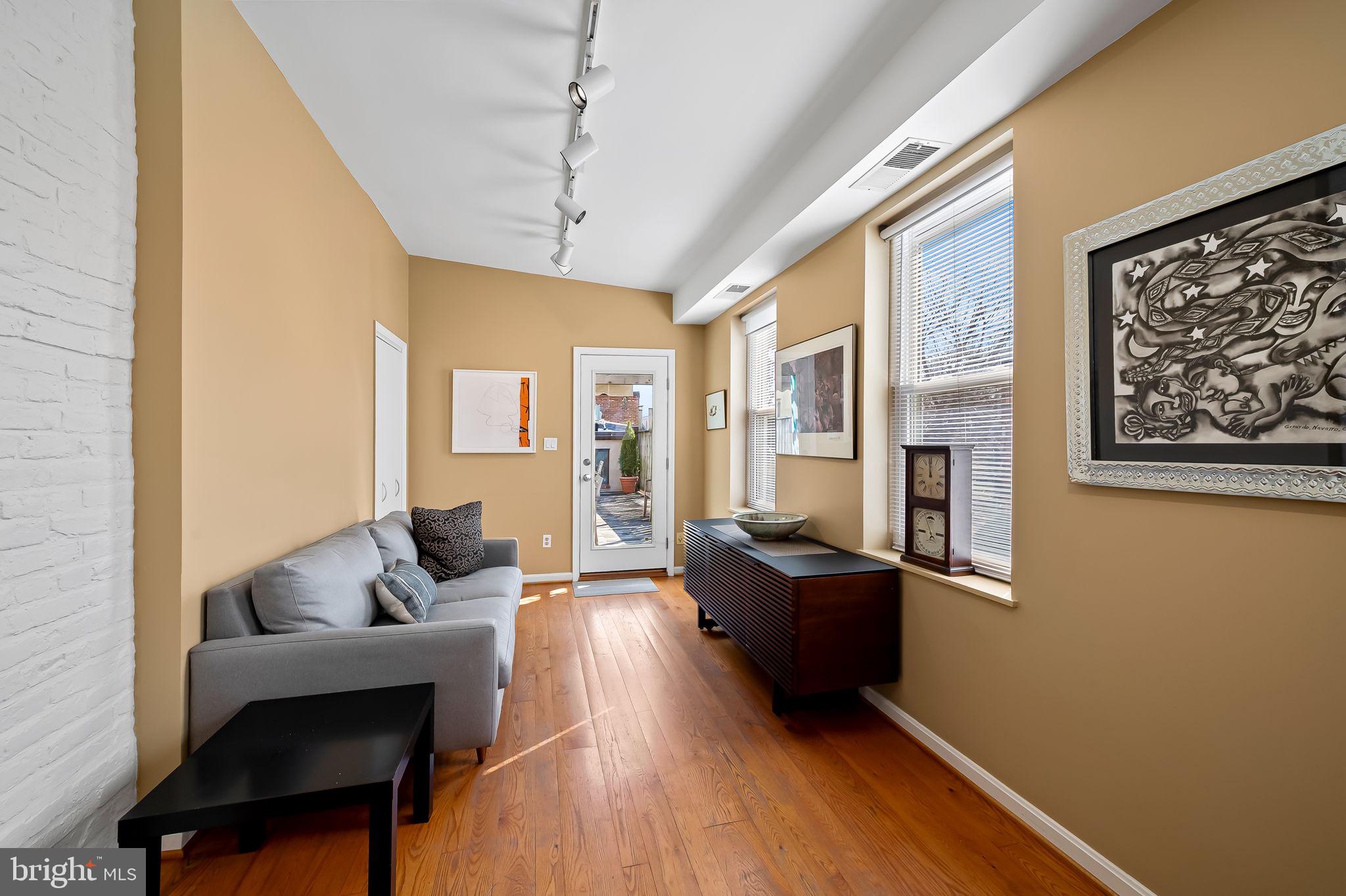 1637 East Baltimore Street Baltimore, MD 21231 - Photo 27 of 39 a living room with furniture and wooden floor