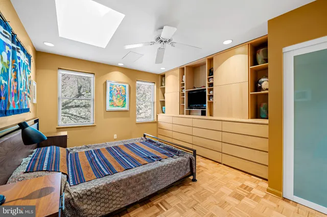 a bedroom with a bed and a painting on the wall