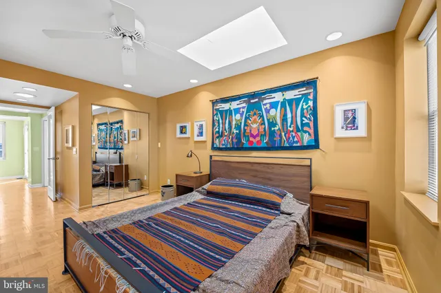 a bedroom with a bed and a painting on the wall