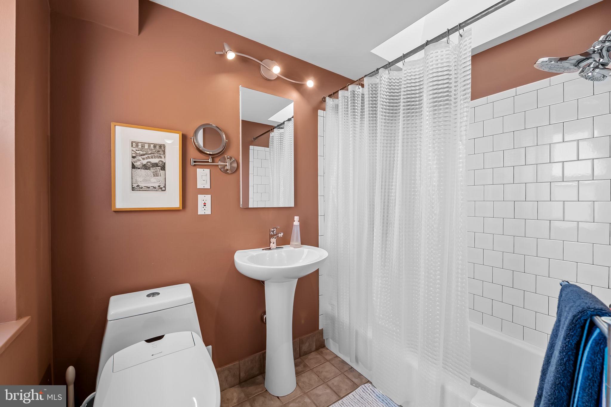 1637 East Baltimore Street Baltimore, MD 21231 - Photo 36 of 39 a bathroom with a sink mirror and toilet