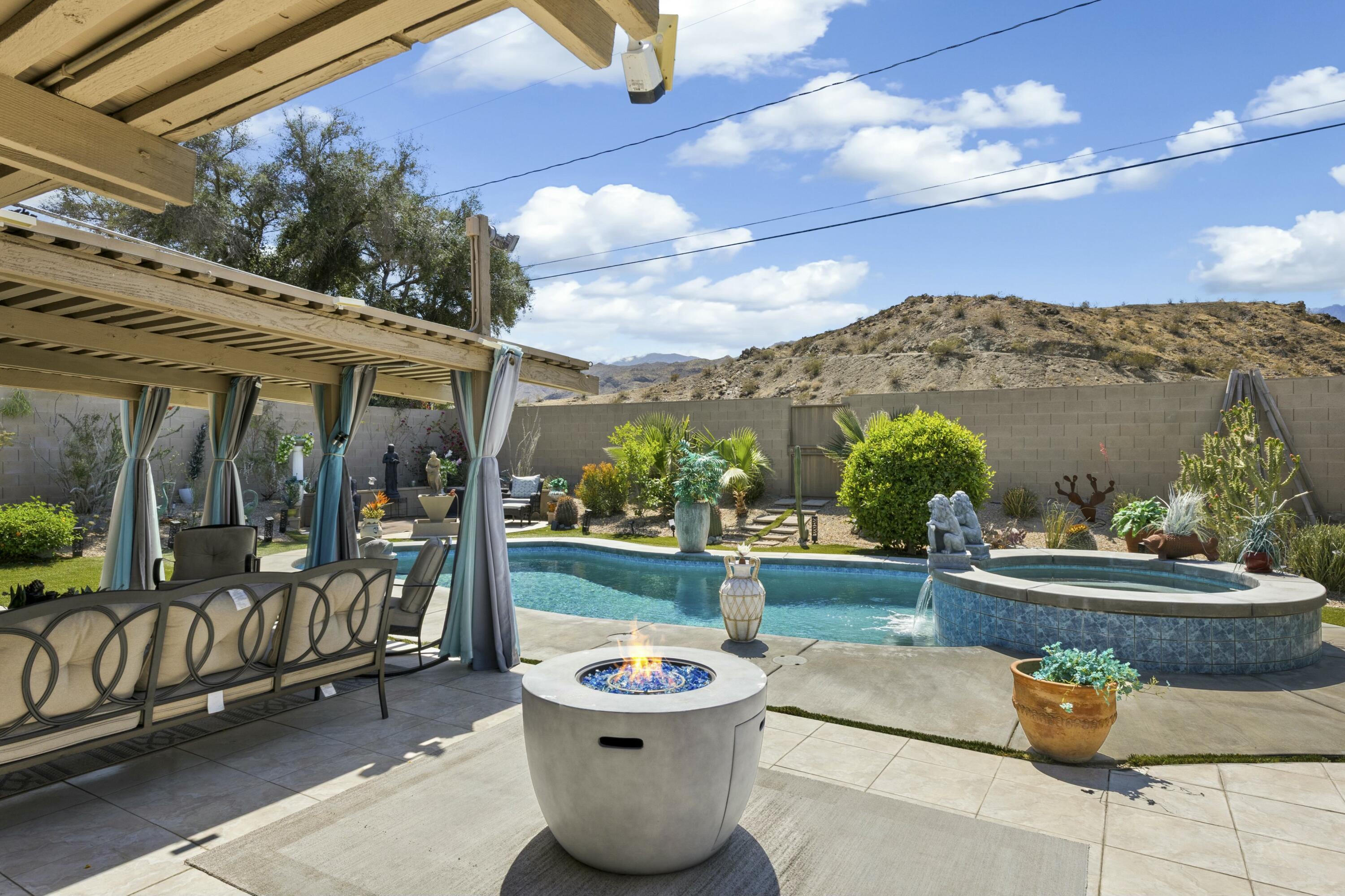 a roof deck with table and chairs and potted plants