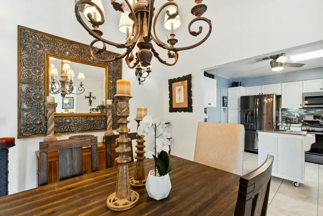 a kitchen with cabinets stainless steel appliances and a window
