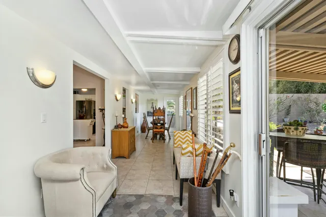 a bedroom with a bed and a flat tv screen on dresser