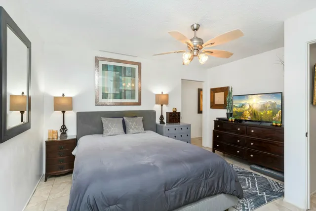 a bedroom with a bed and a chandelier