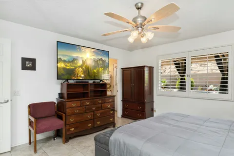 a living room with furniture a piano and a window