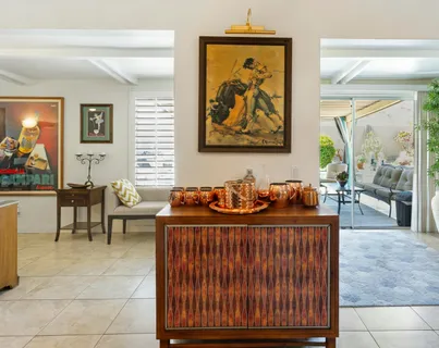 a view of a patio with table and chairs potted plants with wooden floor and fence