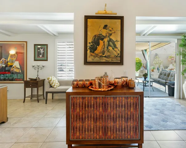 a view of a patio with table and chairs potted plants with wooden floor and fence