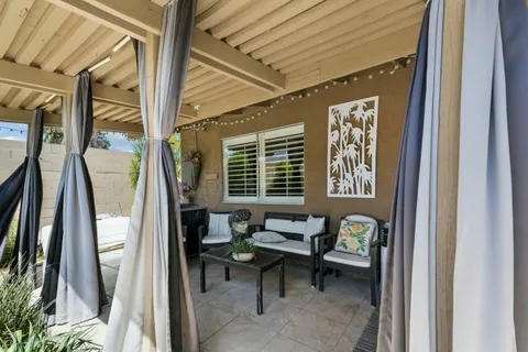 a view of a house with backyard outdoor seating and hardwood