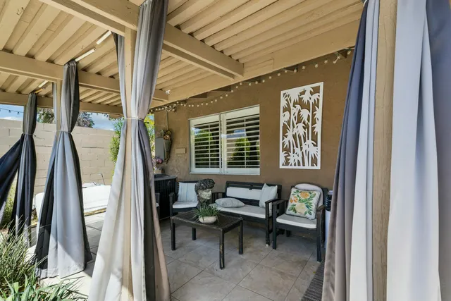 a view of a house with backyard outdoor seating and hardwood