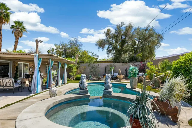 a view of a house with backyard sitting area and garden