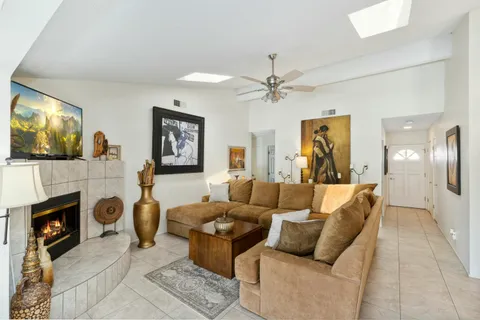 a living room with furniture a flat screen tv and a fireplace
