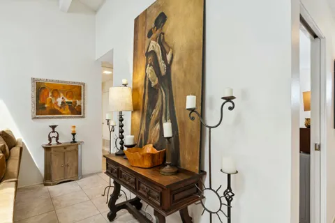 a living room with furniture a rug and a flat screen tv
