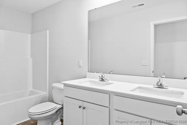 a bathroom with a sink a toilet and bathtub