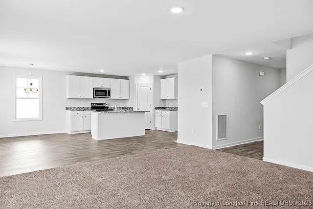 a view of kitchen with wooden floor and electronic appliances