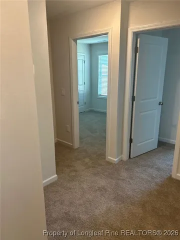 a view of a bathroom from a hallway