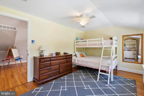 a bedroom with a bunk bed and a desk