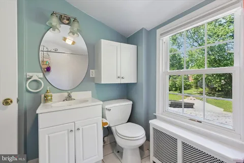 a bathroom with a toilet sink and mirror
