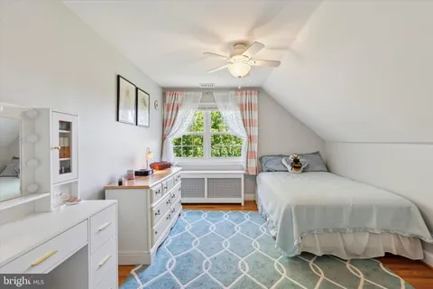 a bedroom with a bed and a table chair