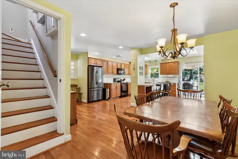a dining room with furniture and wooden floor