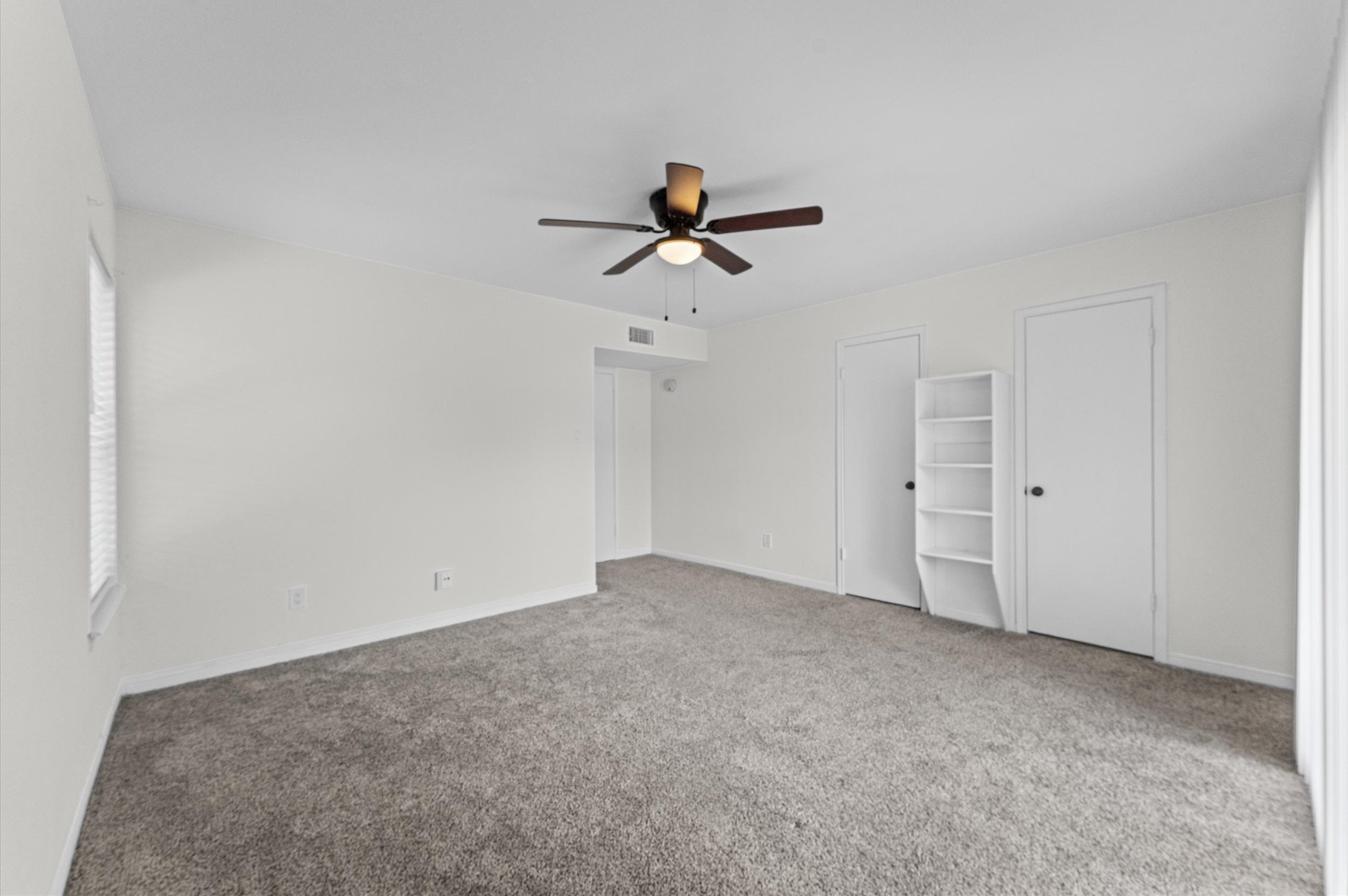 830 Threadneedle Street, Unit 240 Houston, TX 77079 - Photo 16 of 24 14x16 Primary showing the dbl door access to the large closet and built-in shelves.