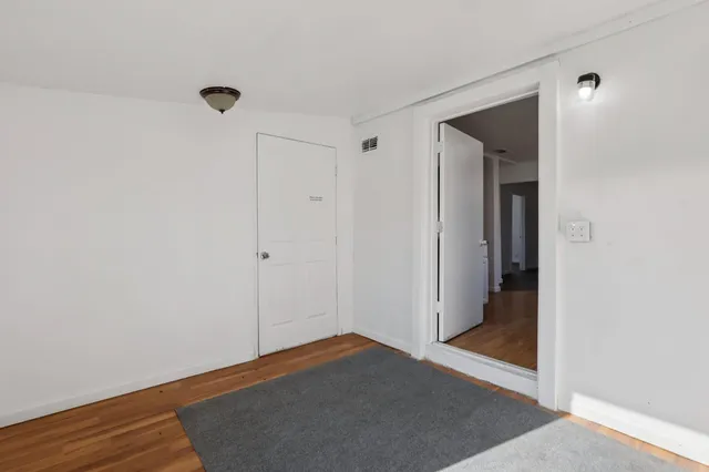 a view of hallway with wooden floor