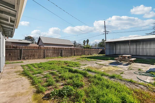 a backyard of a house with barbeque oven