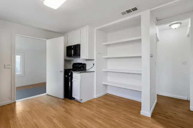 a view of kitchen and wooden floor