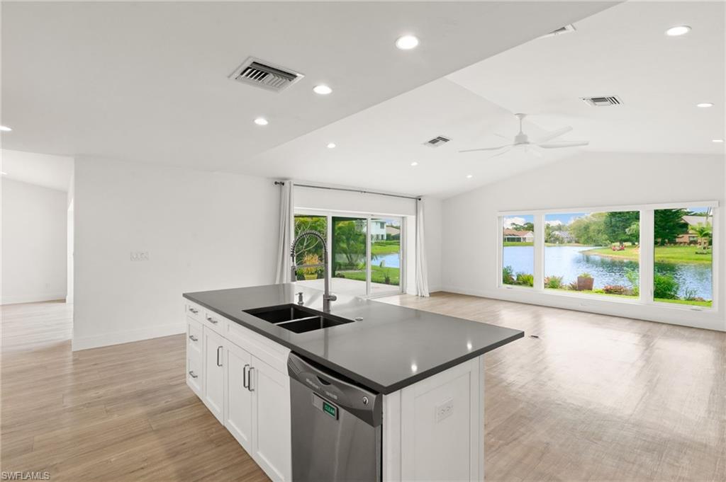 2178 Pinewoods Circle, Unit 25 Naples, FL 34105 - Photo 13 of 45 a kitchen with stainless steel appliances granite countertop a sink and a large window