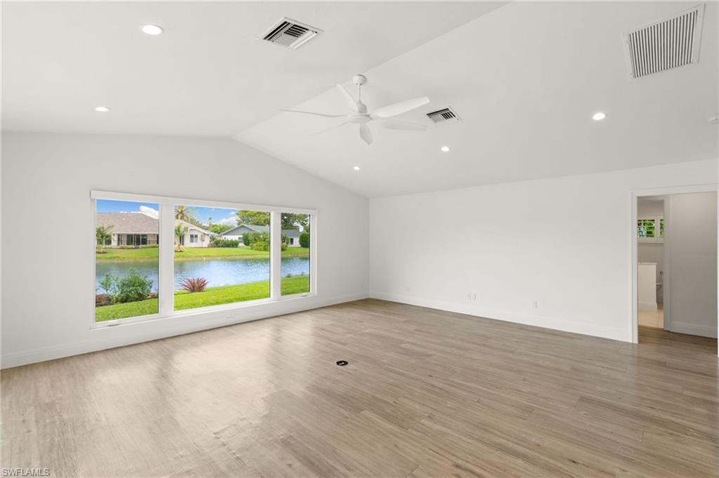 2178 Pinewoods Circle, Unit 25 Naples, FL 34105 - Photo 15 of 45 an empty room with wooden floor and windows