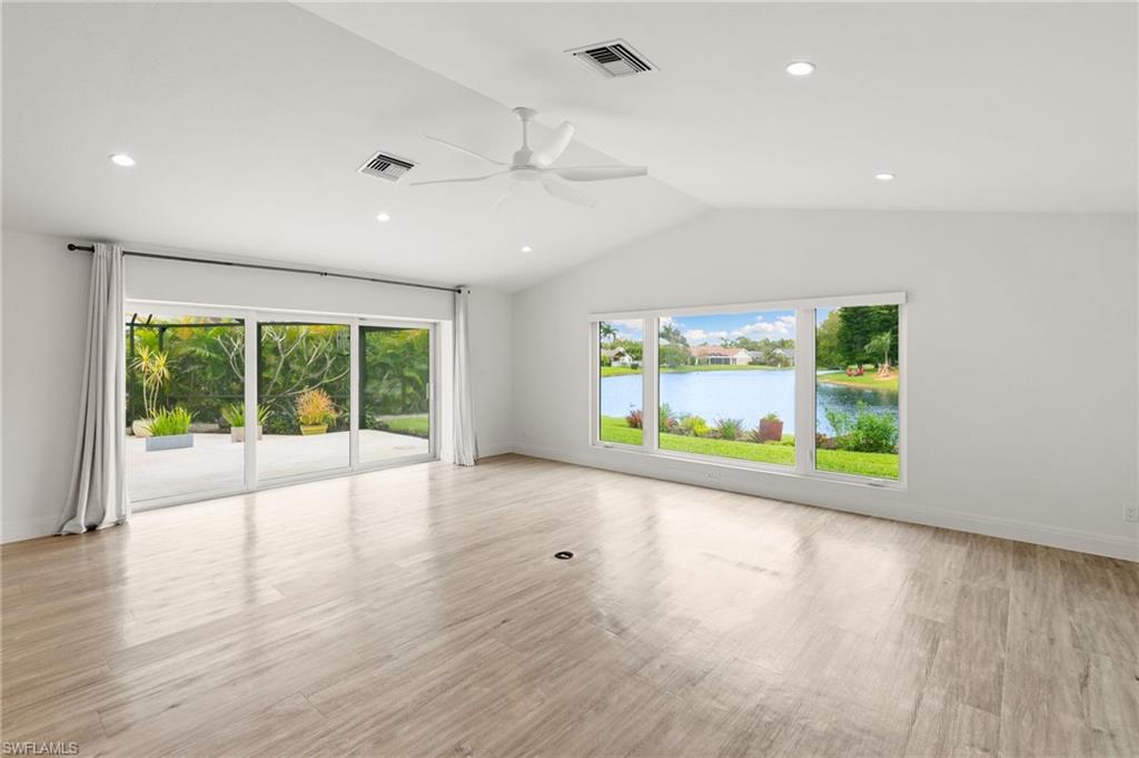 2178 Pinewoods Circle, Unit 25 Naples, FL 34105 - Photo 17 of 45 an empty room with wooden floor and windows