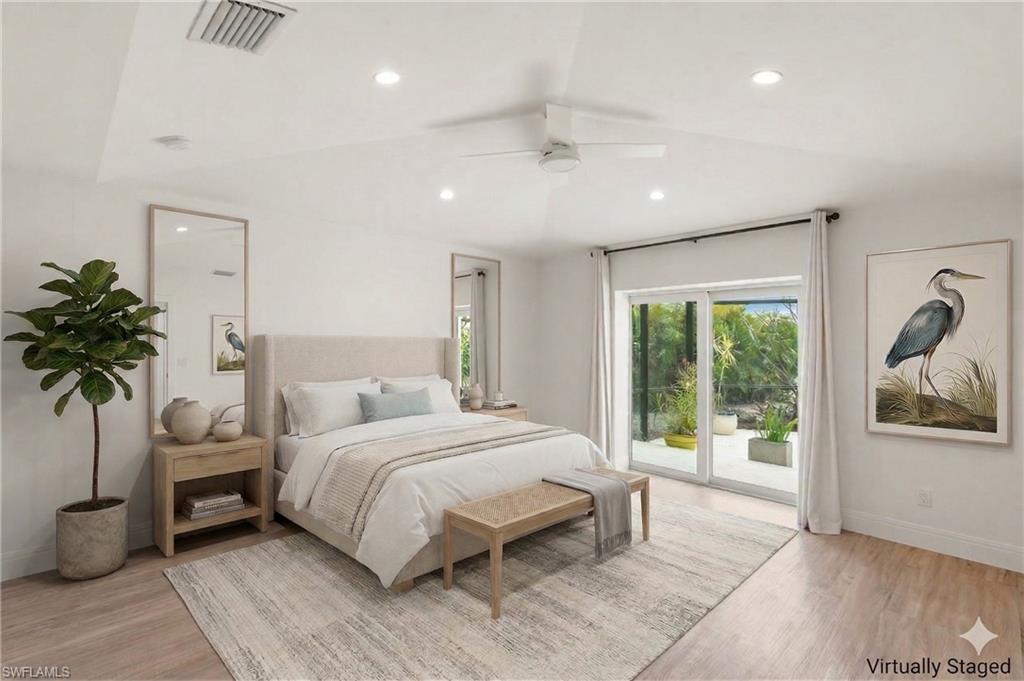 2178 Pinewoods Circle, Unit 25 Naples, FL 34105 - Photo 19 of 45 a bedroom with a large bed and a potted plant