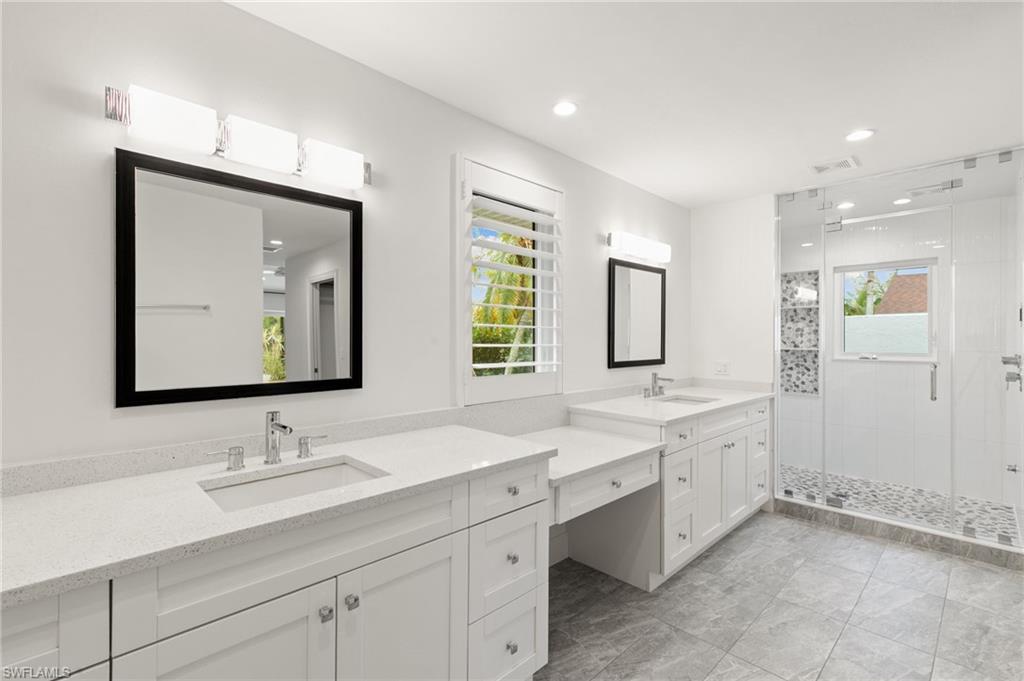 2178 Pinewoods Circle, Unit 25 Naples, FL 34105 - Photo 22 of 45 a bathroom with double sink and a mirror