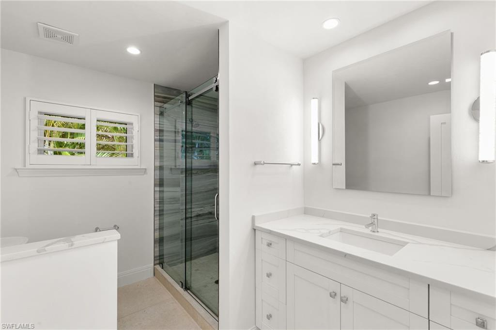 2178 Pinewoods Circle, Unit 25 Naples, FL 34105 - Photo 29 of 45 a bathroom with a shower sink and mirror